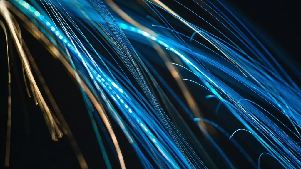 Glowing fibre optic strands in blue and gold - how DNS connects your domain to your website